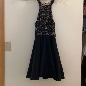 Navy blue, short homecoming dress with back design. Size 7/8.